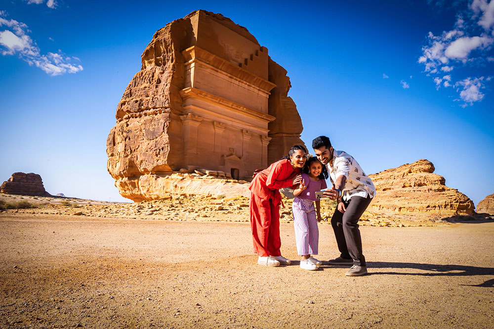 Family standing in front of ancient Nabataean oasis